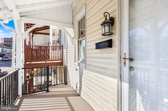 a view of a house with a door and wooden floor