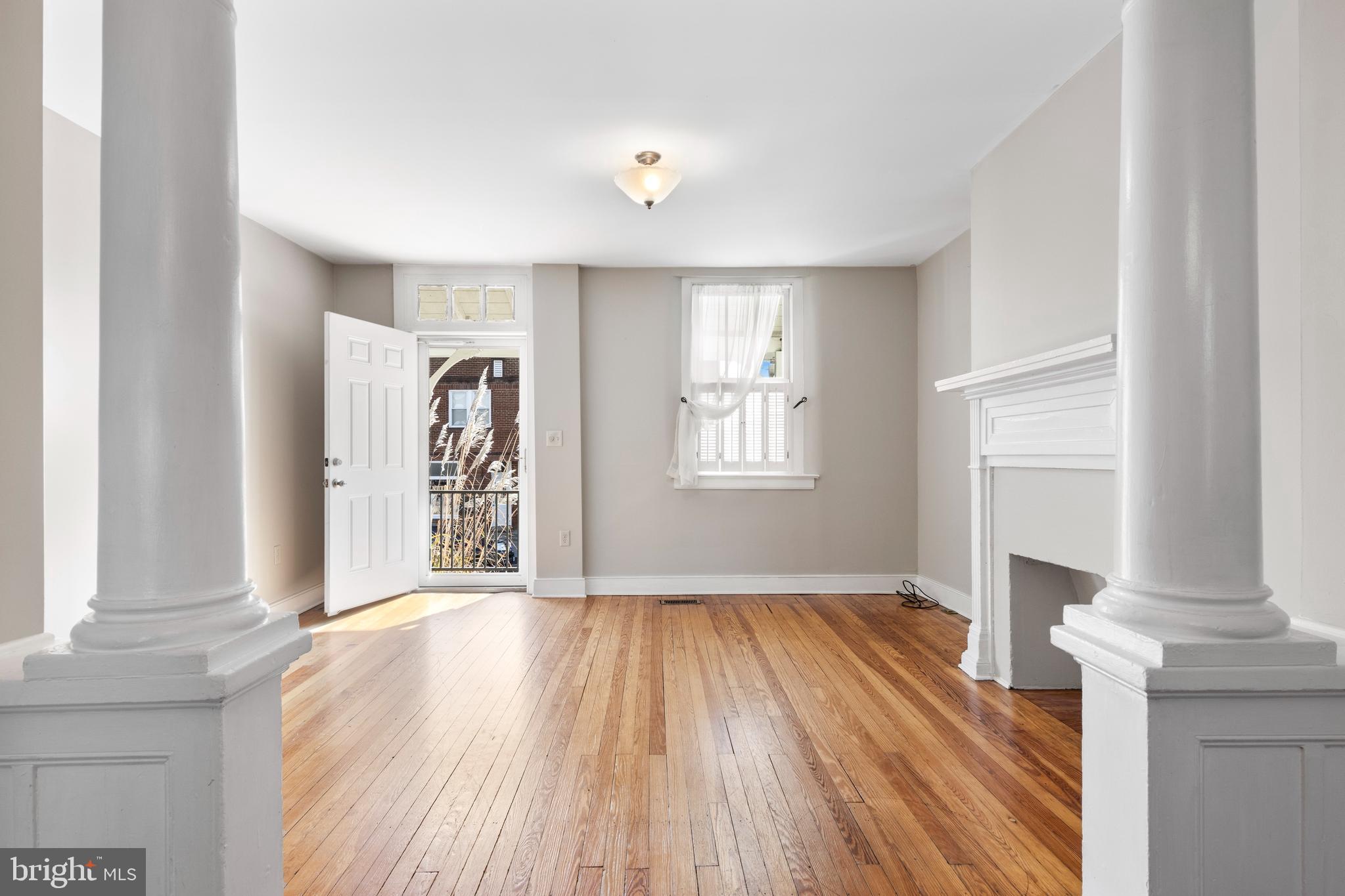 311 State Street Kennett Square, PA 19348 - Photo 6 of 37 an empty room with wooden floor and windows