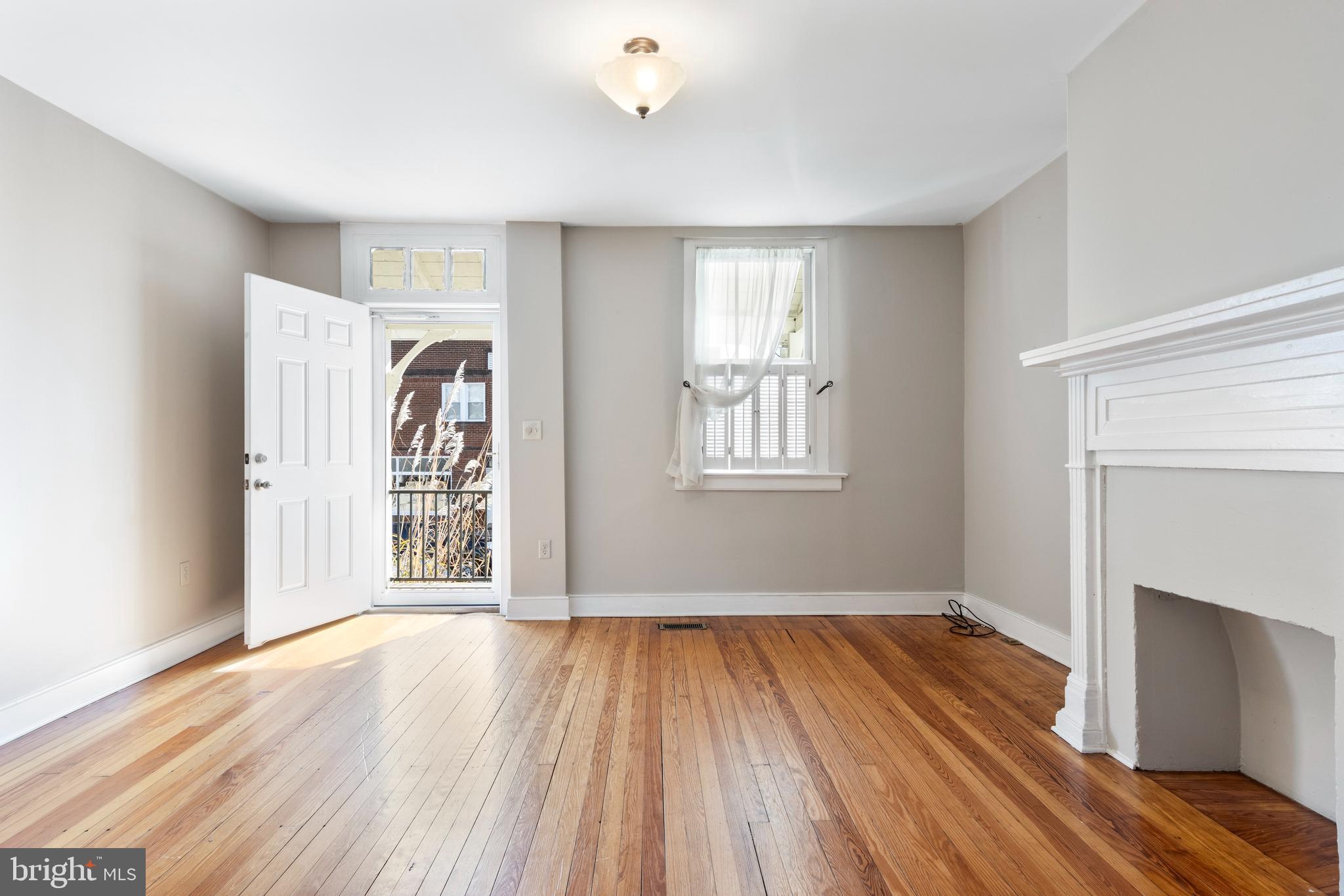 311 State Street Kennett Square, PA 19348 - Photo 7 of 37 an empty room with wooden floor a ceiling fan and windows