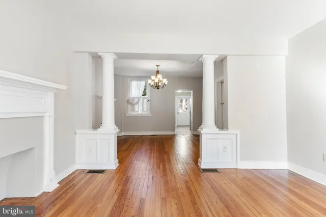 a view of empty room with wooden floor