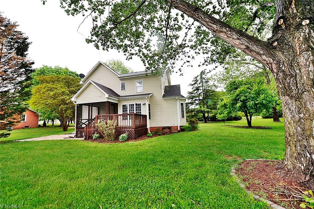 View of Back Deck and Screened Porch. Pretty Level Yard.