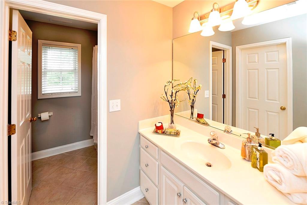 727 Reynolds Road Lewisville, NC 27023 - Photo 21 of 29 Pretty Master Bathroom with Updated Tiled Floors, Tiled Shower Surround and Master Closet