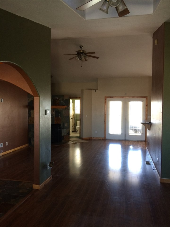 5605 Paradise Road Delta, CO 81416 - Photo 3 of 31 an empty room with wooden floor and windows