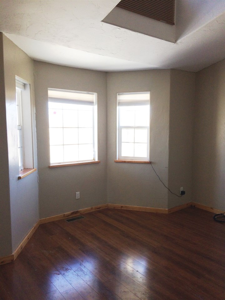 5605 Paradise Road Delta, CO 81416 - Photo 5 of 31 an empty room with wooden floor and windows