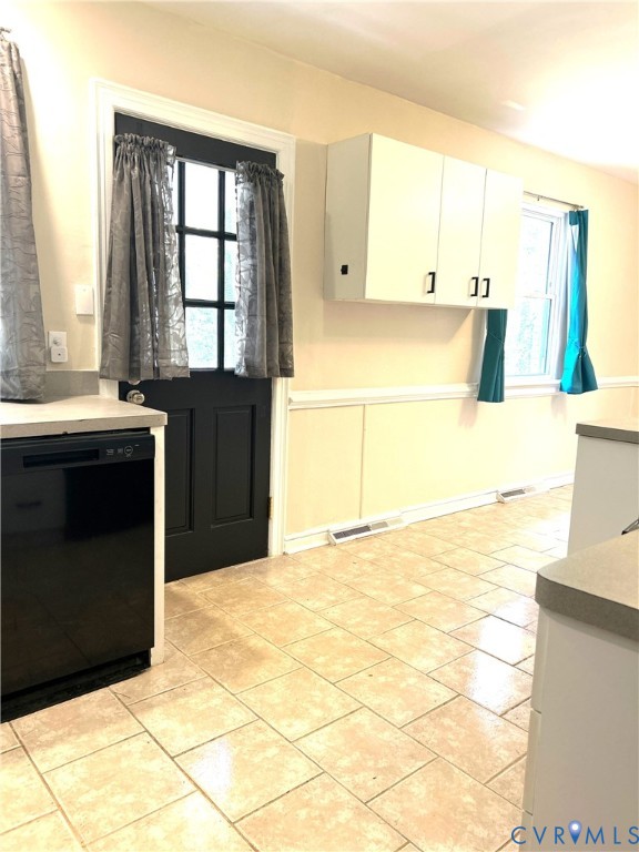 1042 Peck Road Richmond, VA 23235 - Photo 10 of 29 Kitchen featuring white cabinets, black dishwasher