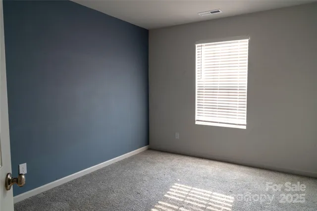 a view of an empty room and a window