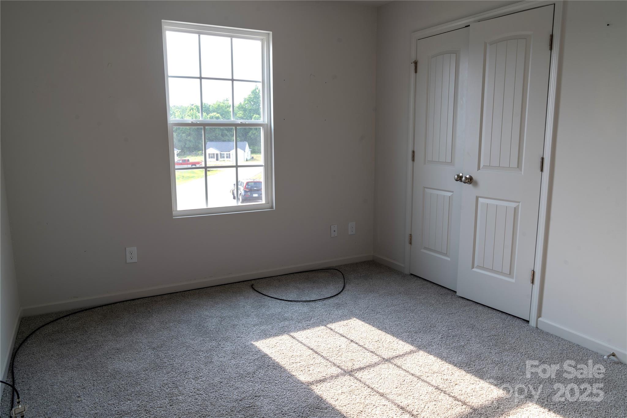 69 Ravibha Court Clayton, NC 27520 - Photo 13 of 16 an empty room with windows