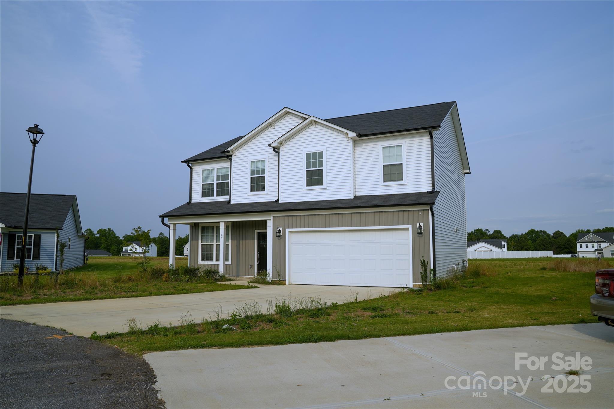 69 Ravibha Court Clayton, NC 27520 - Photo 2 of 16 a front view of a house with a yard and garage