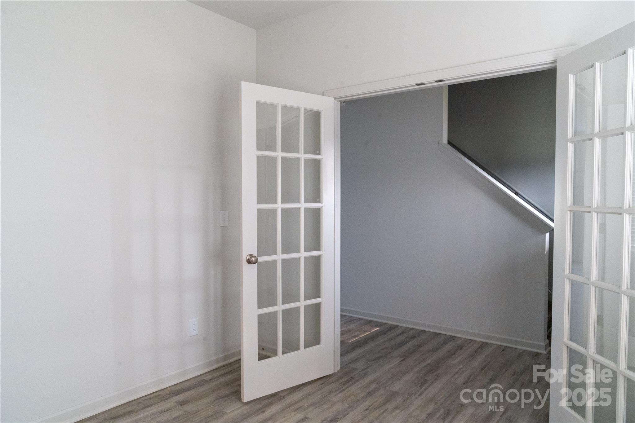 69 Ravibha Court Clayton, NC 27520 - Photo 5 of 16 an empty room with wooden floor and windows
