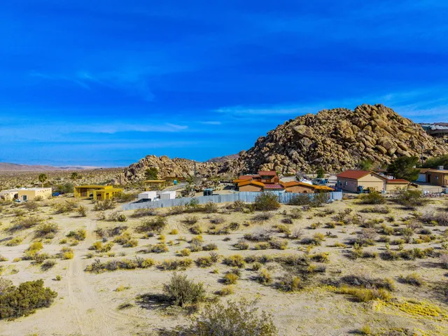 a view of a large building with mountains in the background