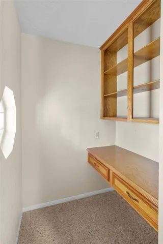 an empty room with closet and chandelier fan