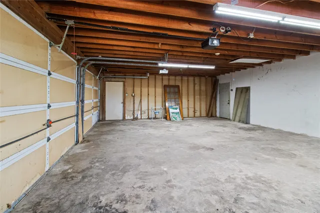 a view of a big room with wooden cabinet and door