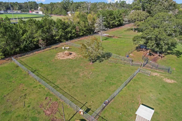 a view of an empty room with glass door and a window