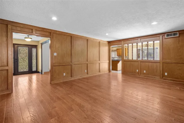 a view of kitchen with kitchen island granite countertop a refrigerator and a sink