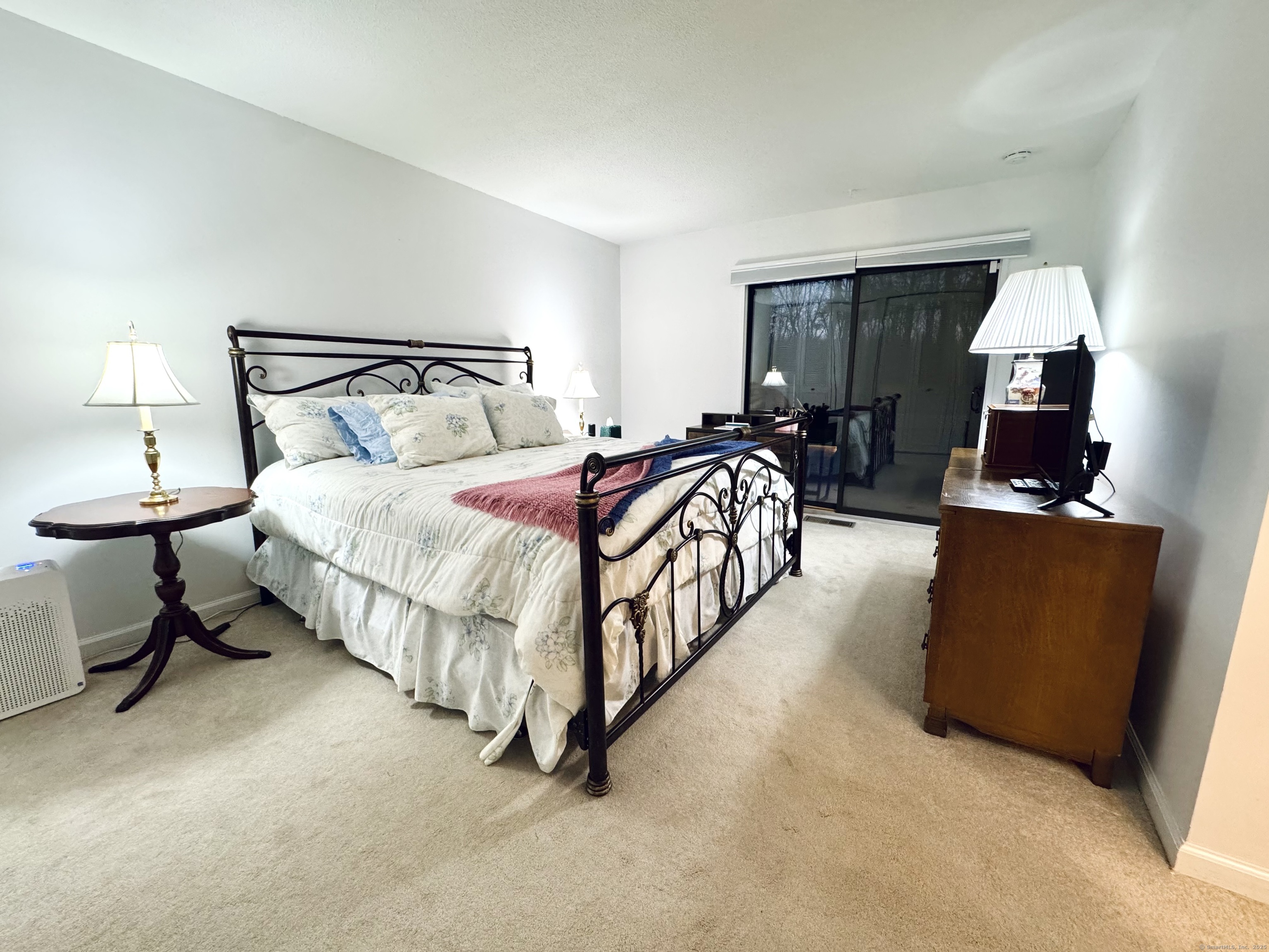 7 Honeysuckle Lane, Unit 7 Ridgefield, CT 06877 - Photo 16 of 22 Master Bedroom with Sliding Glass Doors Leading to Deck