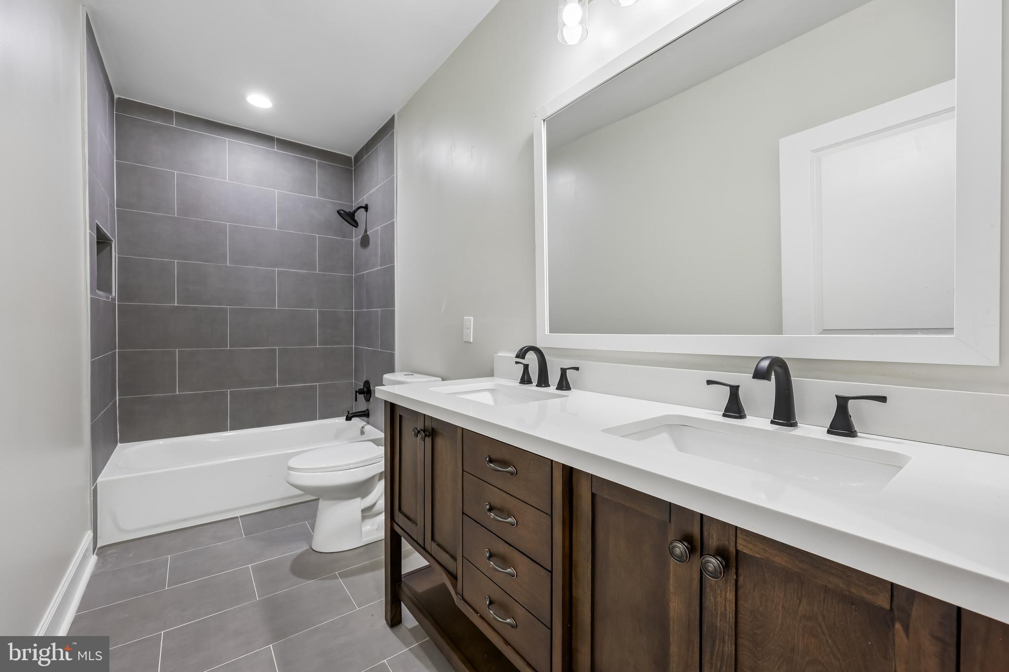 12304 Popes Head Road Fairfax, VA 22030 - Photo 52 of 78 a bathroom with a sink a toilet and shower