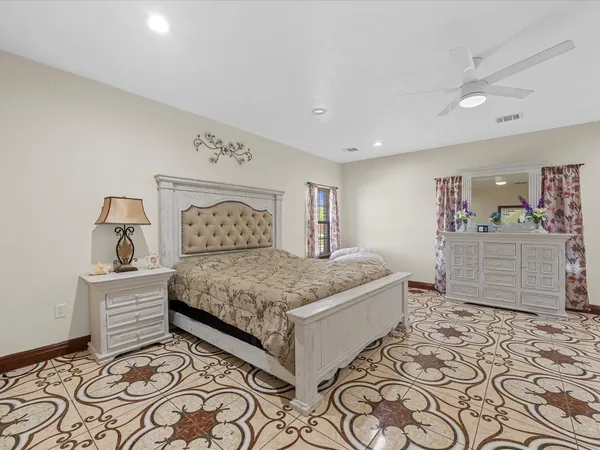 a bedroom with a bed and a view of kitchen