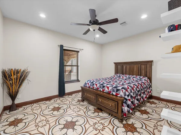 a bedroom with a large bed and a chandelier