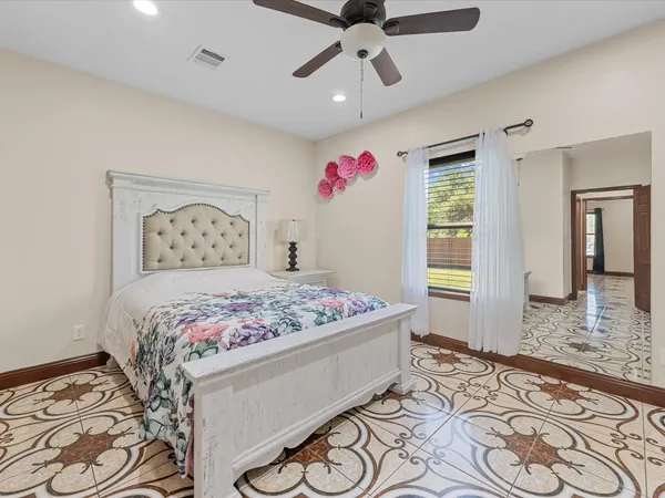 a bedroom with a bed and a television