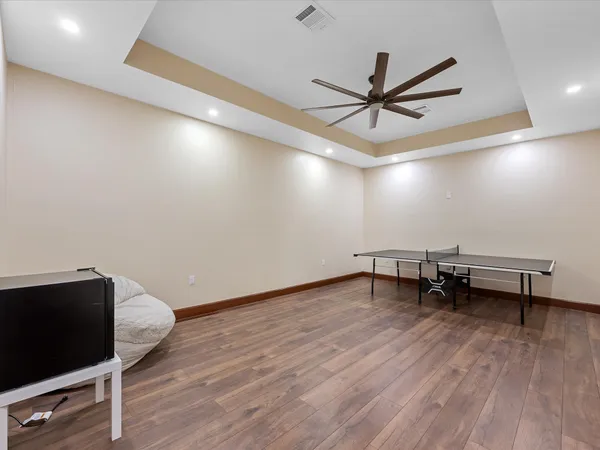 a bedroom with a bed wooden floor and window