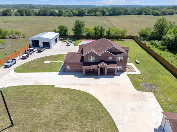 an aerial view of a house with a swimming pool