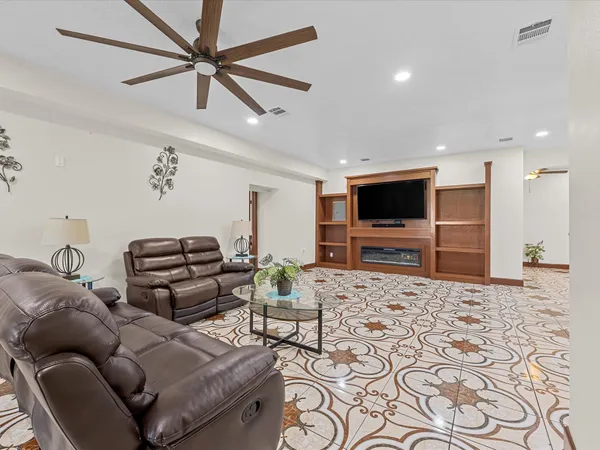a large room with lots of chairs and wooden floor