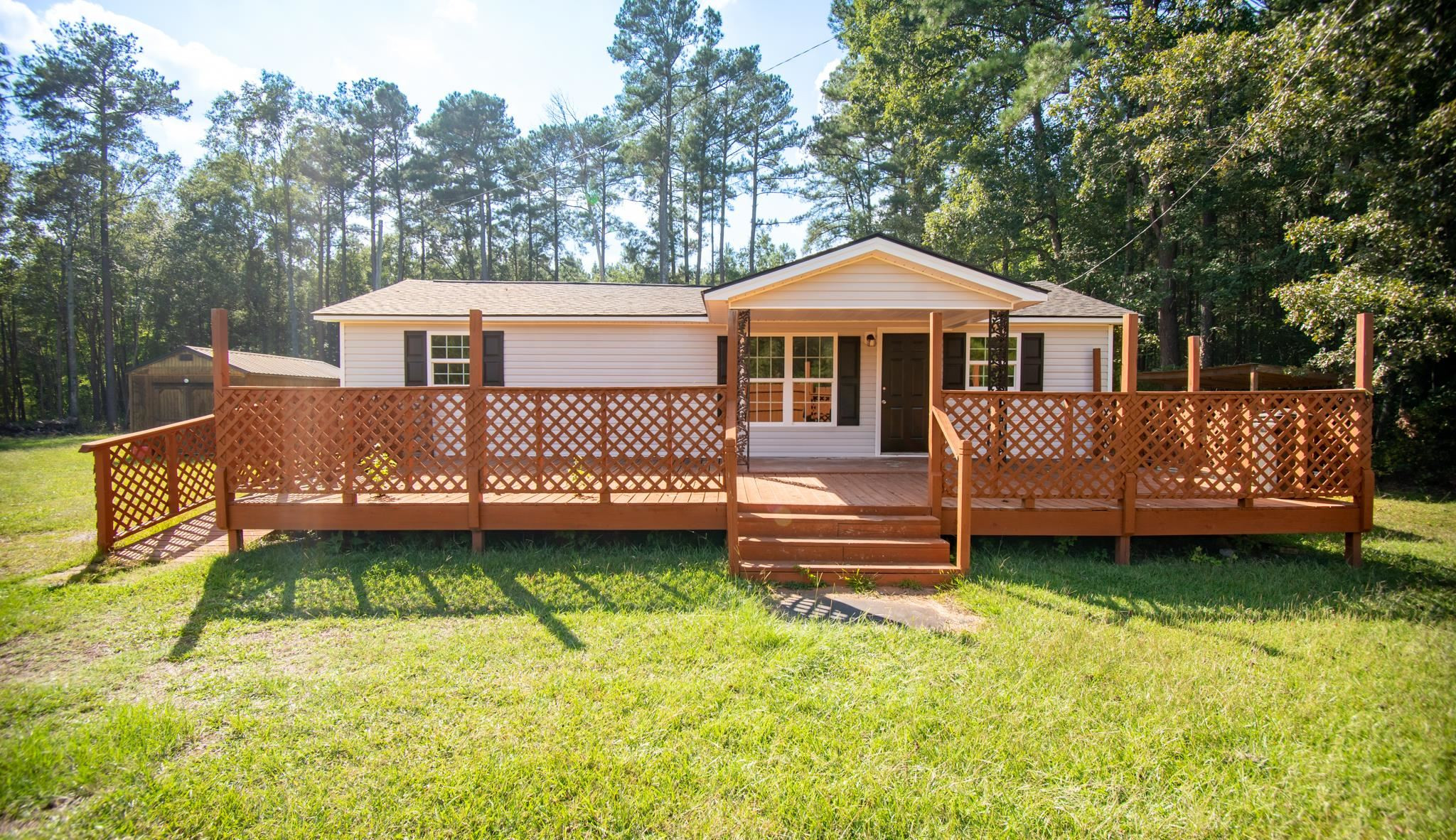 560 Covington Road Bunnlevel, NC 28323 - Photo 1 of 19 a front view of a house with a yard table and chairs