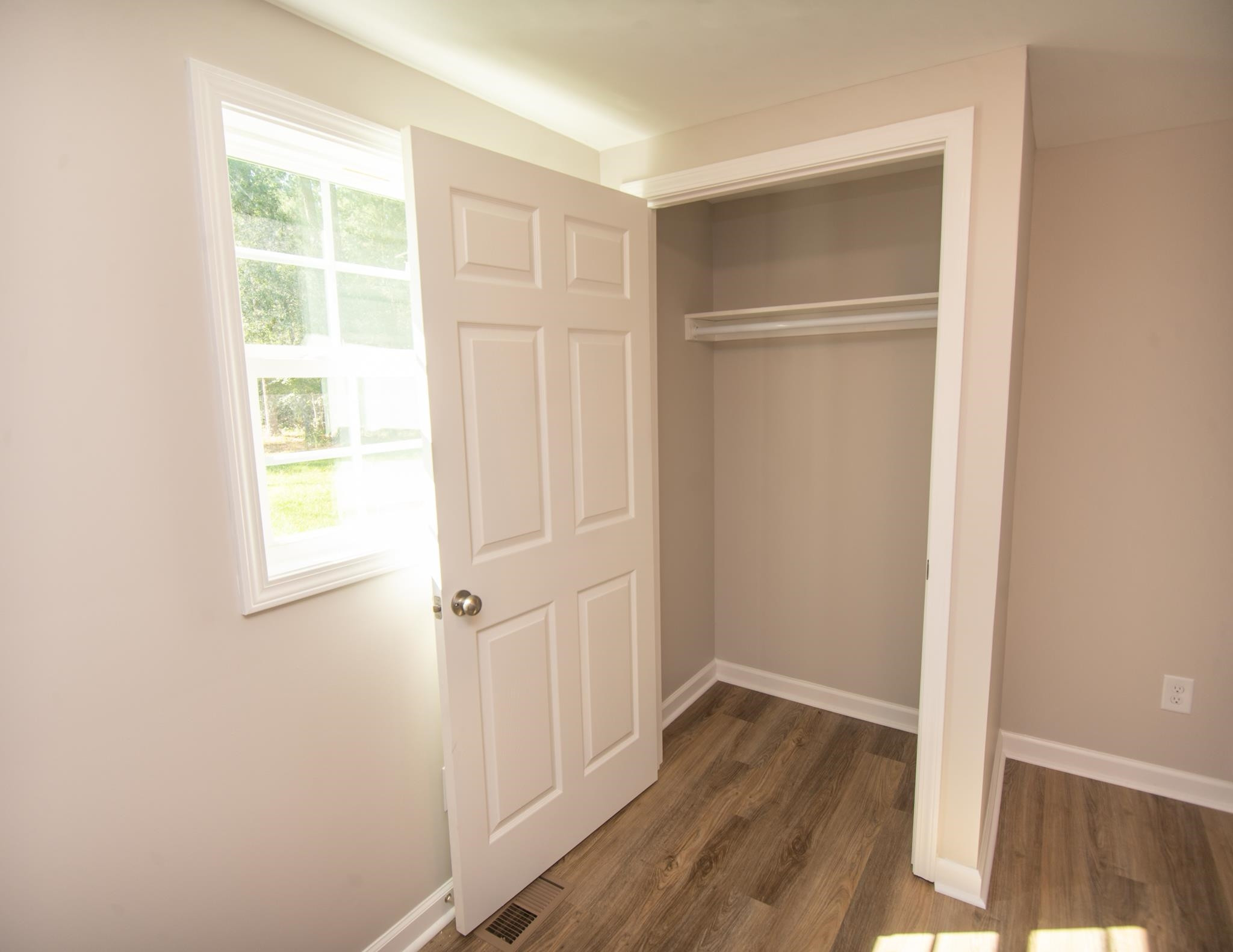 560 Covington Road Bunnlevel, NC 28323 - Photo 11 of 19 a view of an empty room with wooden floor and a window