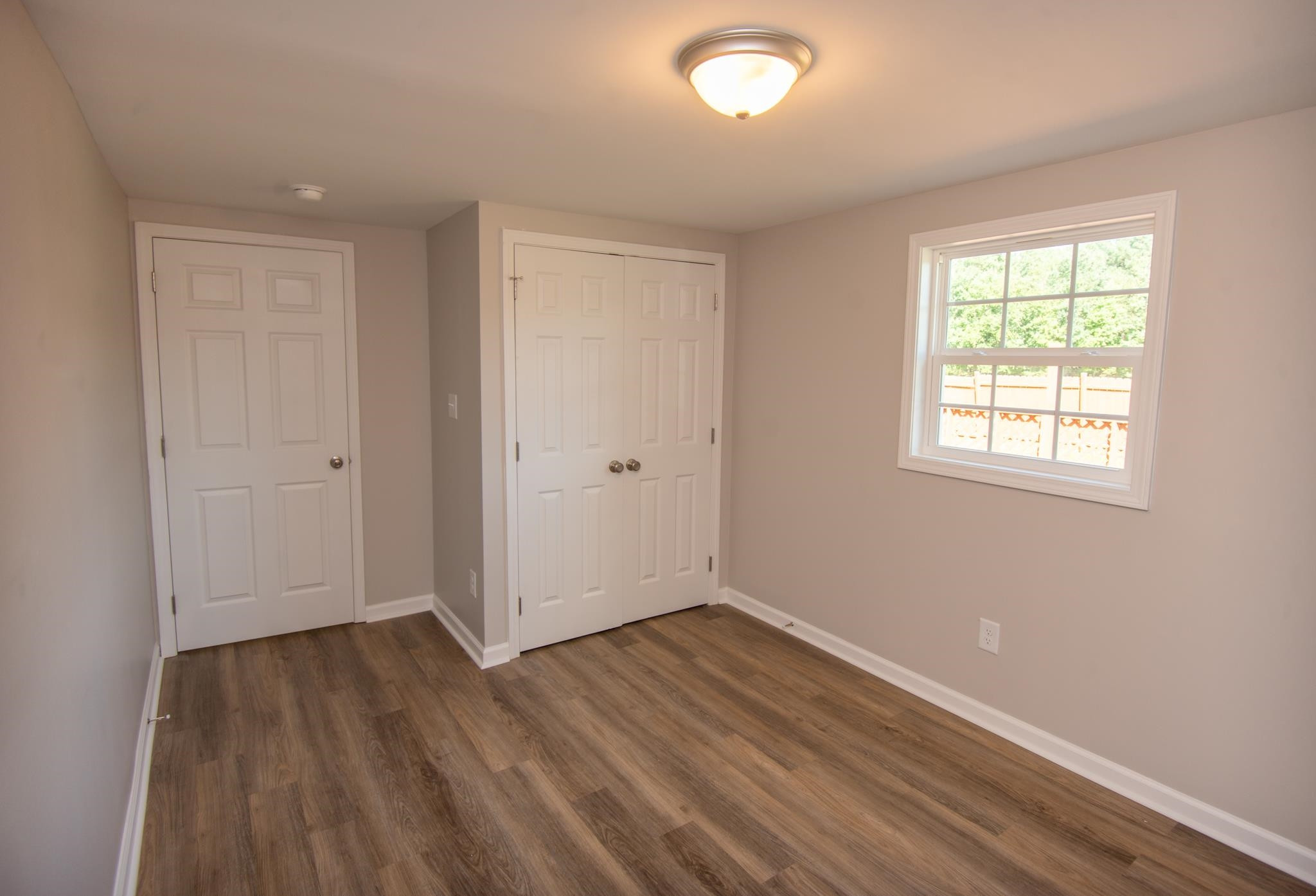 560 Covington Road Bunnlevel, NC 28323 - Photo 14 of 19 an empty room with wooden floor and windows