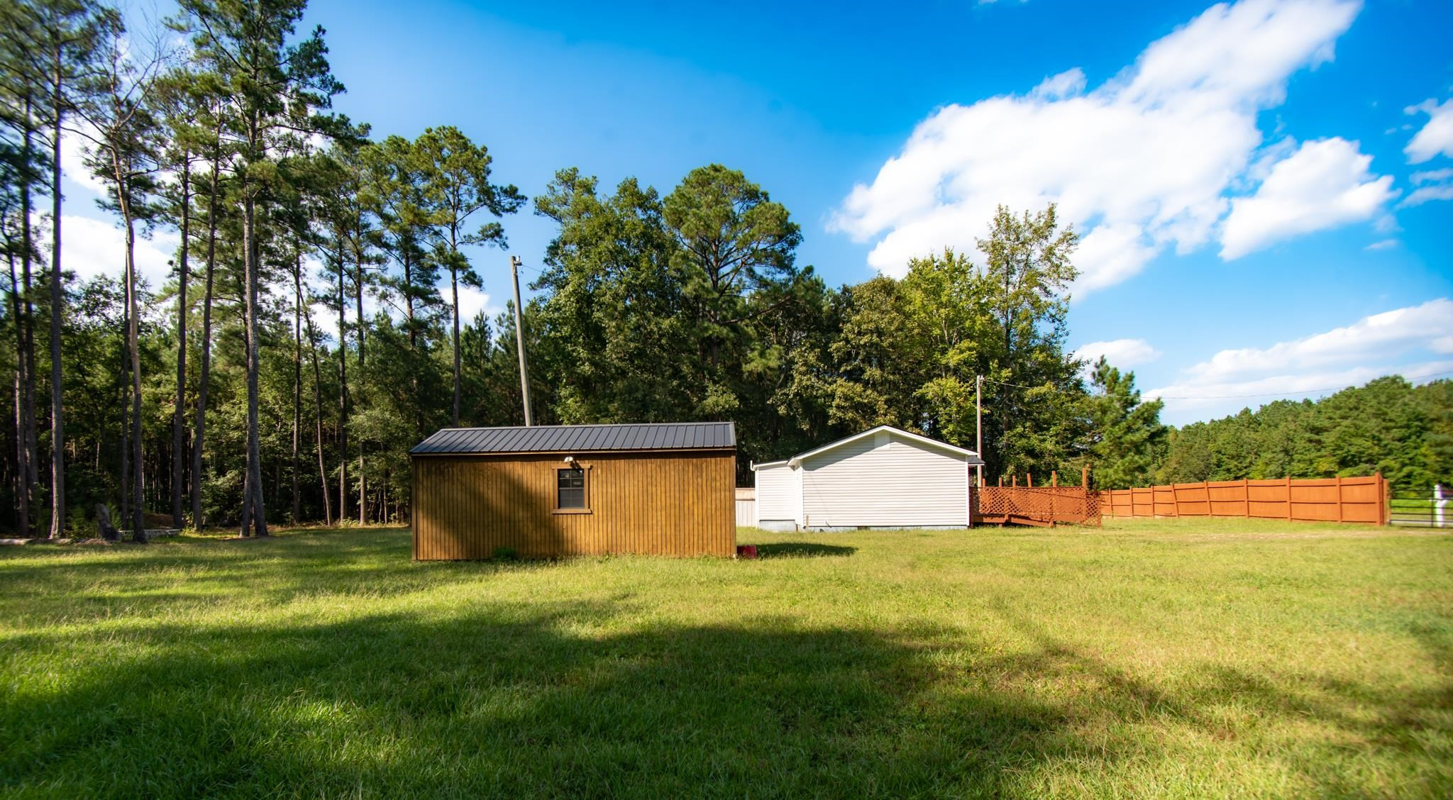 560 Covington Road Bunnlevel, NC 28323 - Photo 16 of 19 a view of a house with pool and a yard