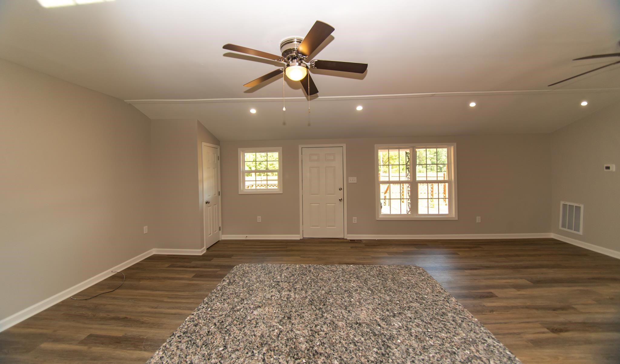 560 Covington Road Bunnlevel, NC 28323 - Photo 3 of 19 an empty room with wooden floor and windows