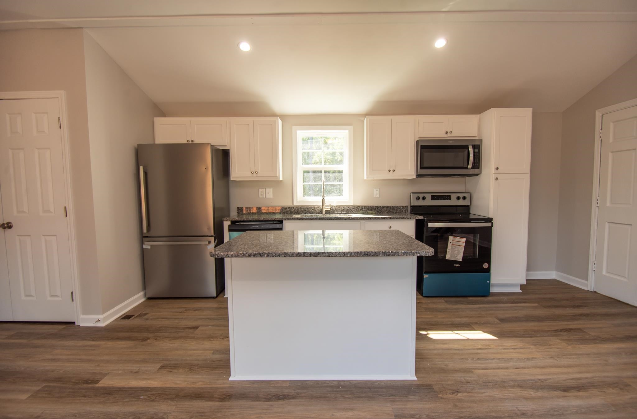 560 Covington Road Bunnlevel, NC 28323 - Photo 4 of 19 a kitchen with kitchen island a counter top space a refrigerator and a stove top oven