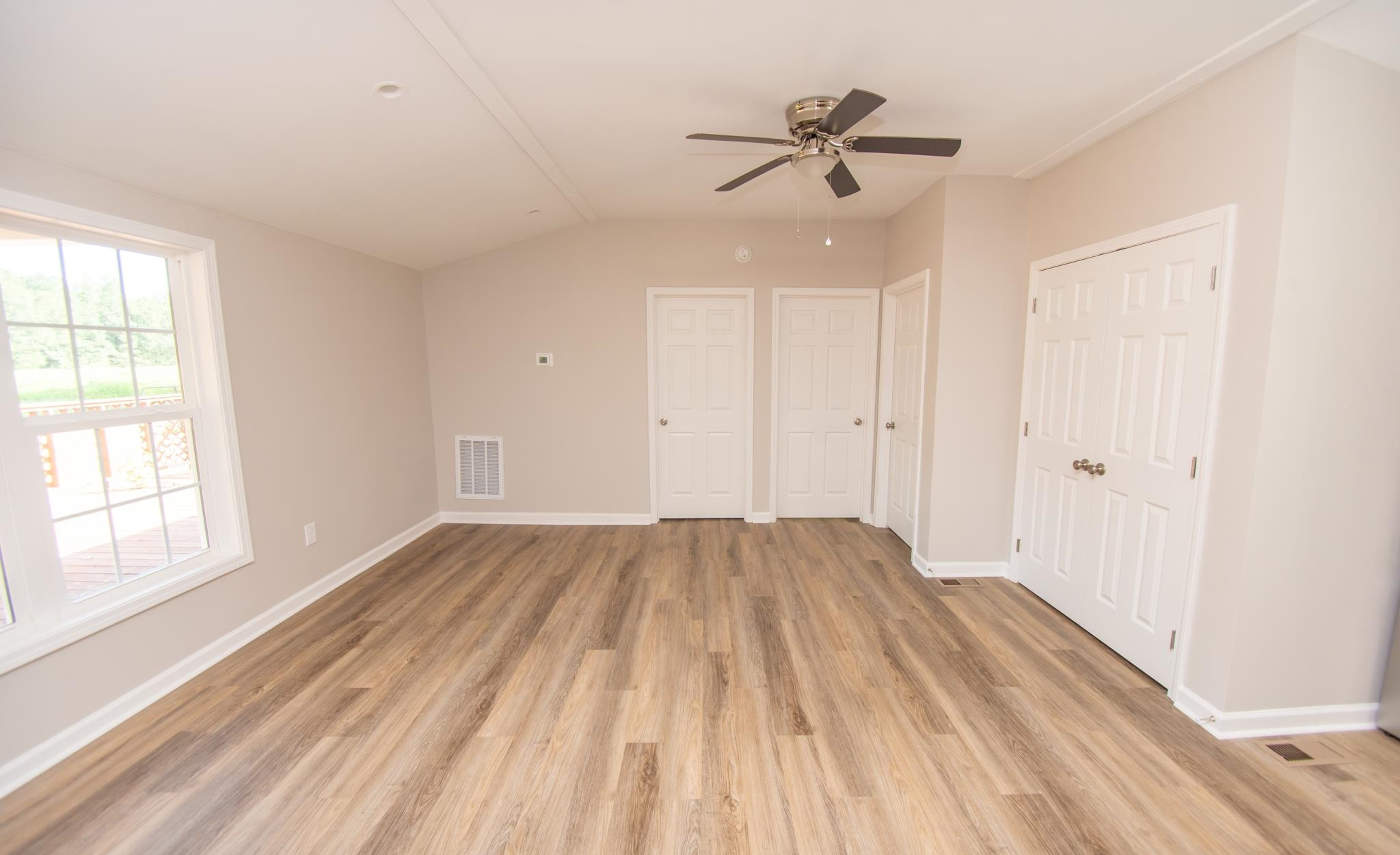 560 Covington Road Bunnlevel, NC 28323 - Photo 6 of 19 wooden floor in an empty room with a window