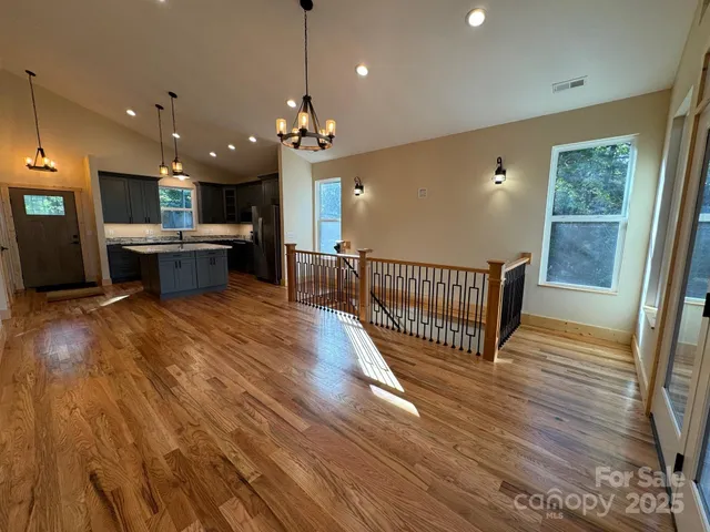 a view of a kitchen and dining room with wooden floor