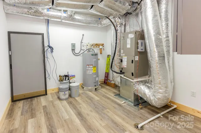 an empty room with wooden floor a fireplace and a window