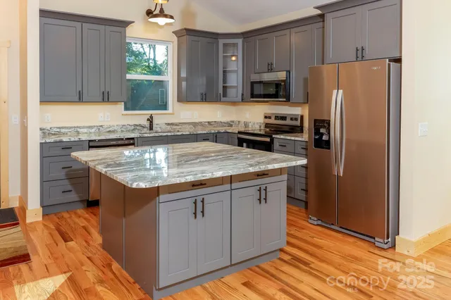 a kitchen with a refrigerator sink and microwave