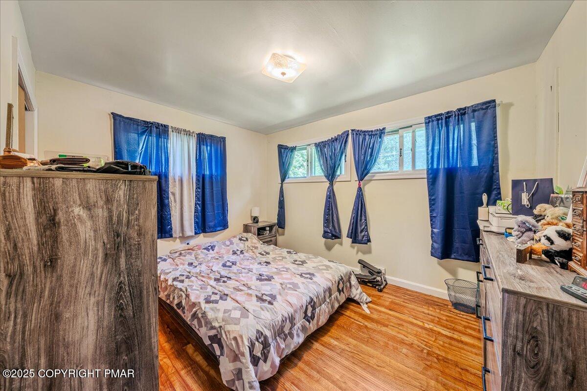 119 Knob Road Mount Pocono, PA 18344 - Photo 22 of 34 a bedroom with a bed and a refrigerator