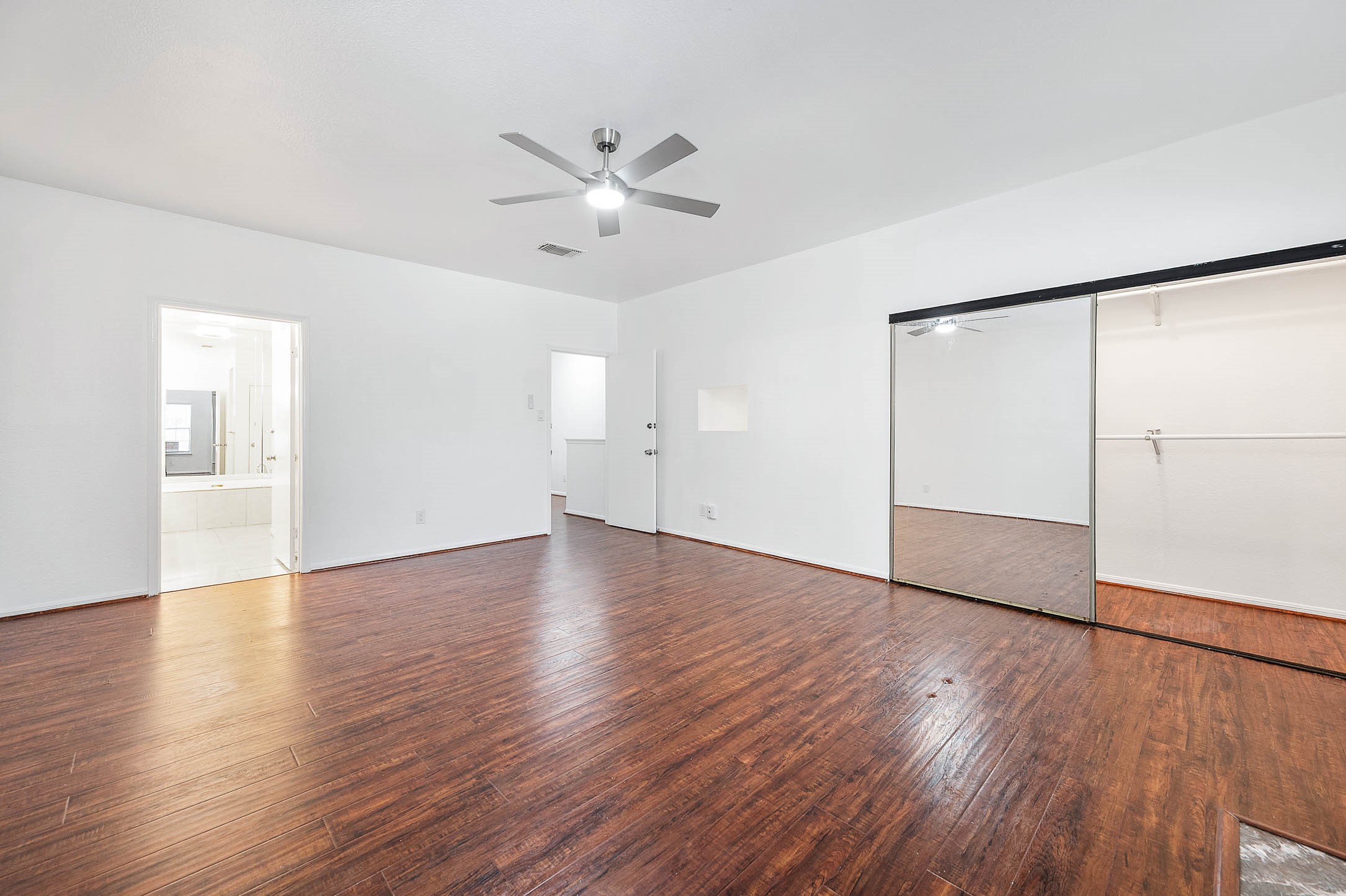 6000 Reims Road, Unit 2003 Houston, TX 77036 - Photo 14 of 24 an empty room with wooden floor closet and windows