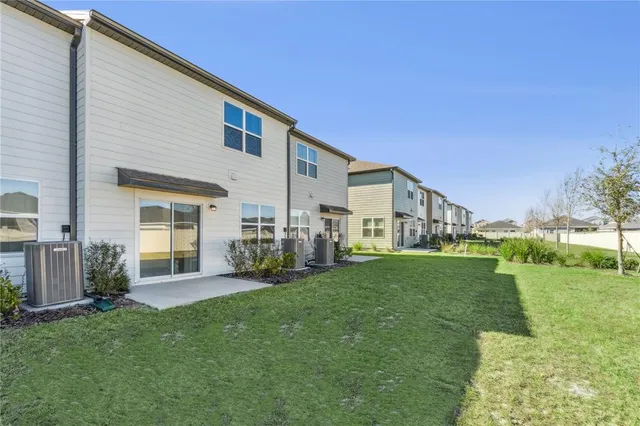 a view of a house with a yard and sitting area