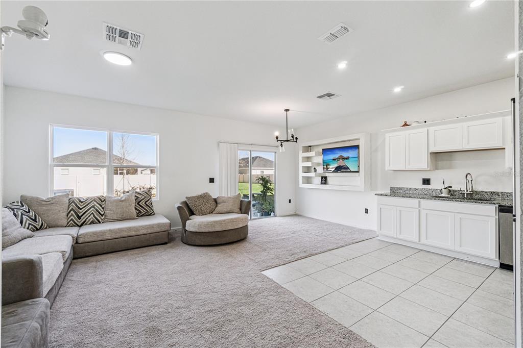 5931 Chestnut Grv Place St. Cloud, FL 34771 - Photo 3 of 20 a living room with furniture and a potted plant