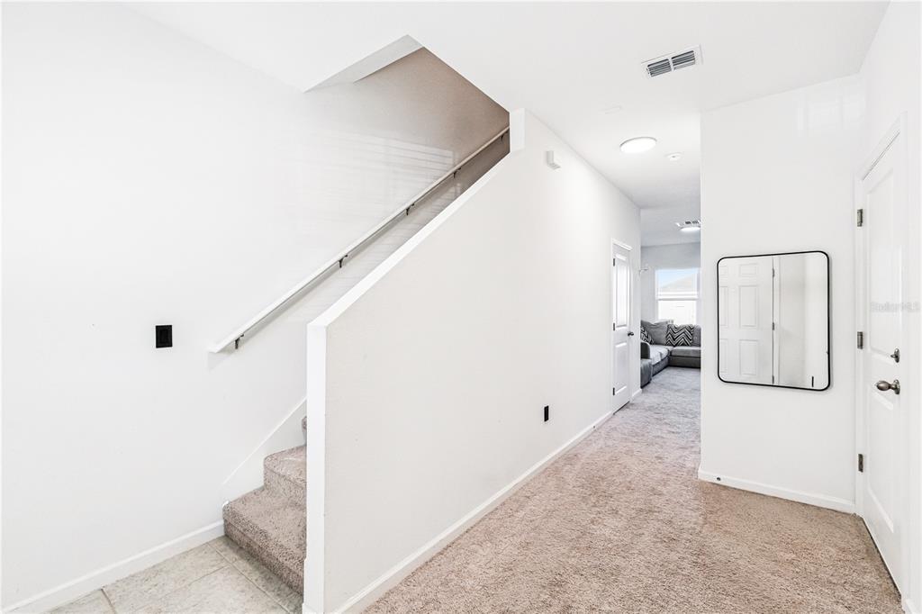 5931 Chestnut Grv Place St. Cloud, FL 34771 - Photo 7 of 20 a view of a livingroom with wooden floor and staircase