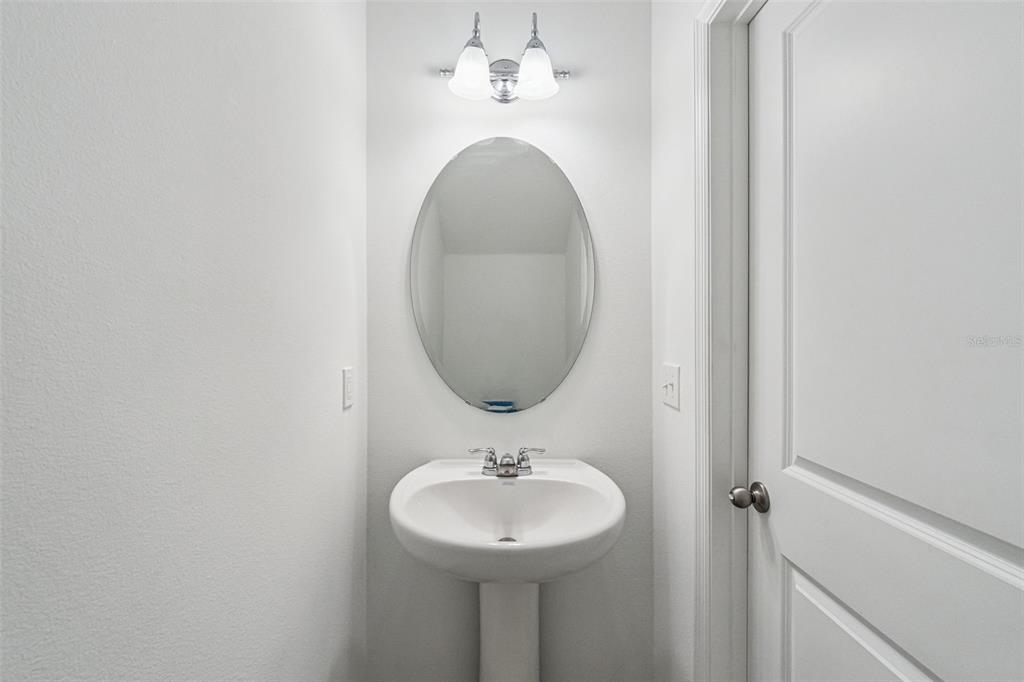 5931 Chestnut Grv Place St. Cloud, FL 34771 - Photo 8 of 20 a bathroom with a sink and a mirror