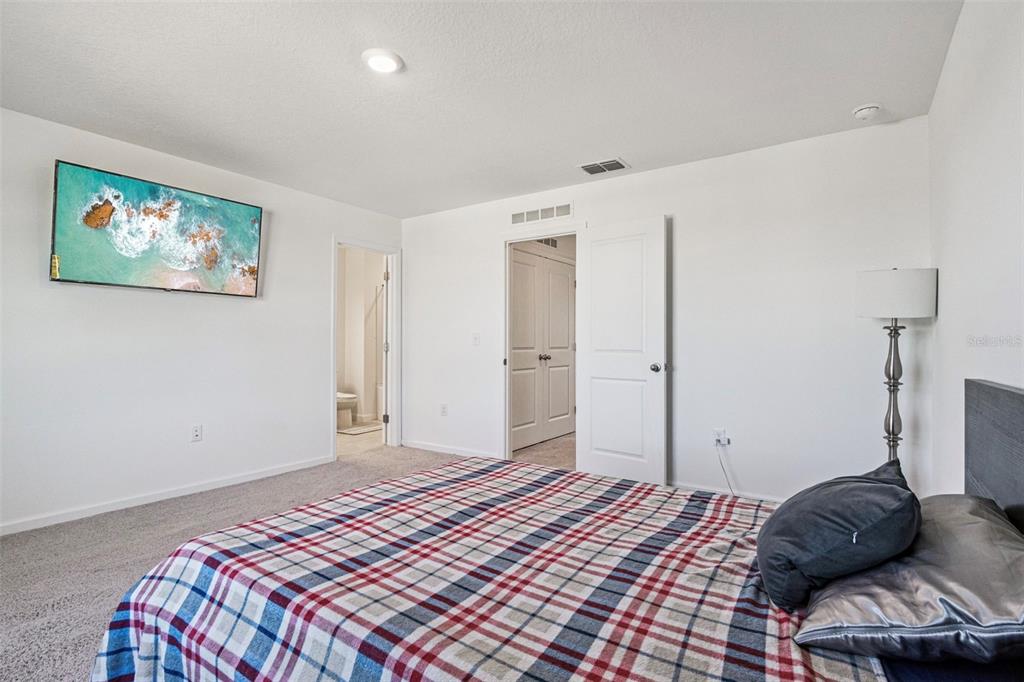 5931 Chestnut Grv Place St. Cloud, FL 34771 - Photo 9 of 20 a bedroom with a bed and a couch