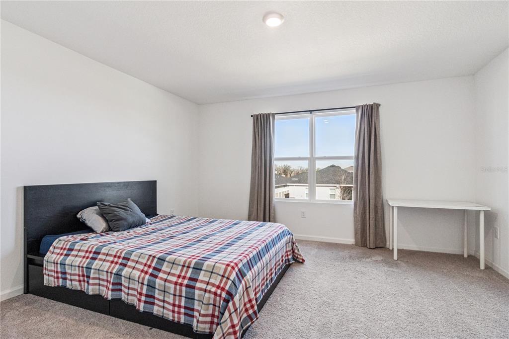 5931 Chestnut Grv Place St. Cloud, FL 34771 - Photo 10 of 20 a bedroom with a bed and window