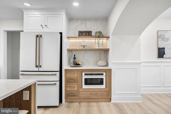 a kitchen with white cabinets and a fireplace