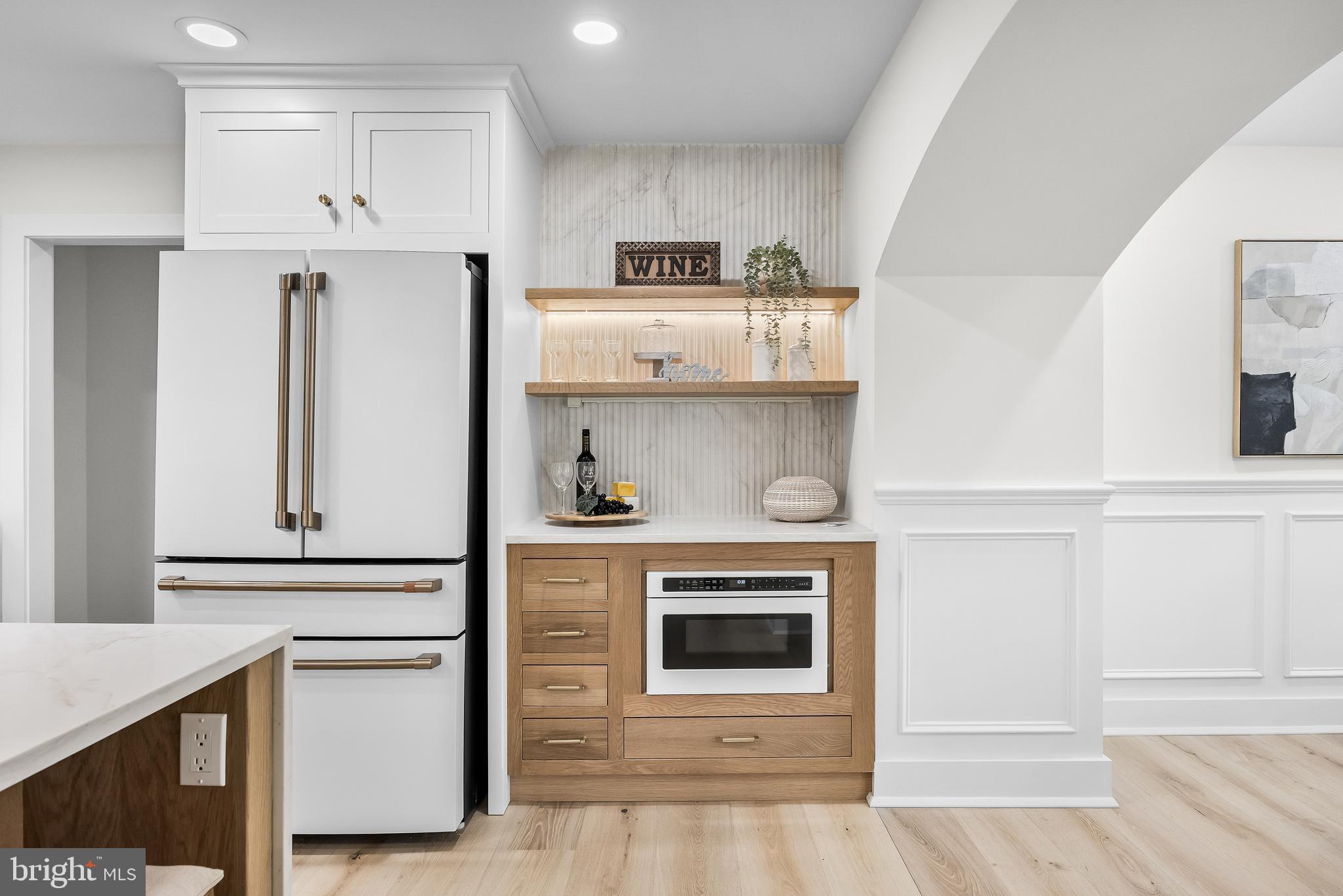 201 Centre Street Haddonfield, NJ 08033 - Photo 11 of 48 a kitchen with white cabinets and a fireplace