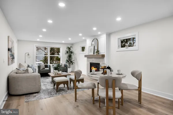 a living room with fireplace furniture and a wooden floor