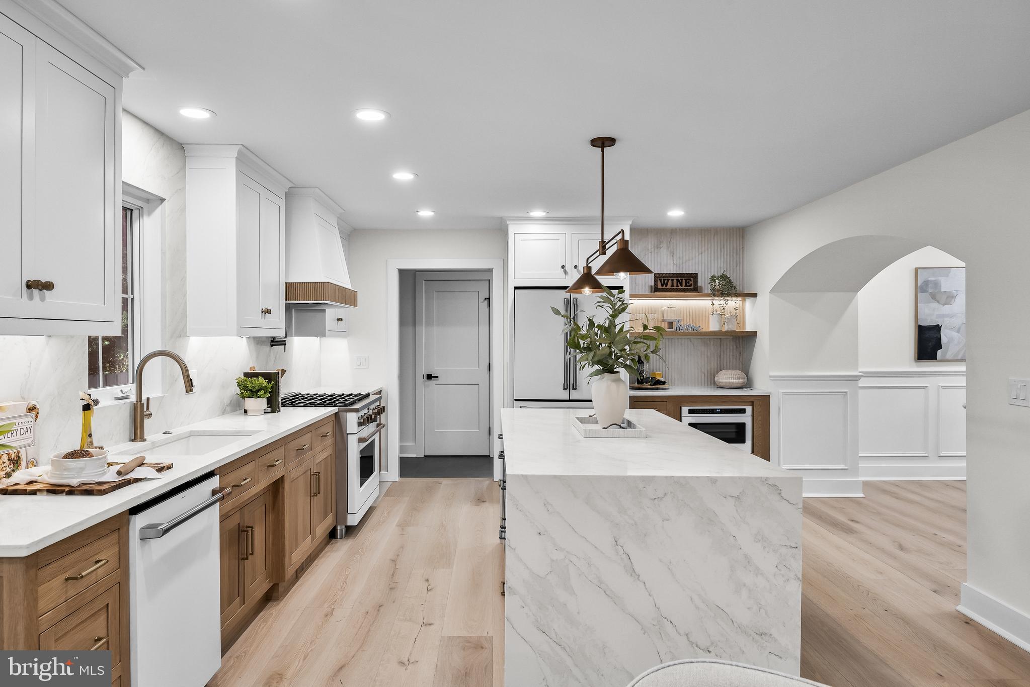 201 Centre Street Haddonfield, NJ 08033 - Photo 20 of 48 a large kitchen with stainless steel appliances kitchen island granite countertop a stove a sink a refrigerator and white cabinets with wooden floor