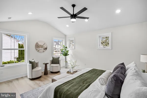 a bedroom with furniture and a large window
