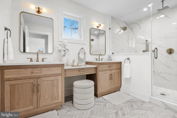 a spacious bathroom with a double vanity sink mirror and double